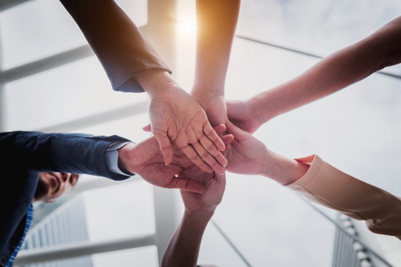 Group of business people joining hands. Team work concept.
