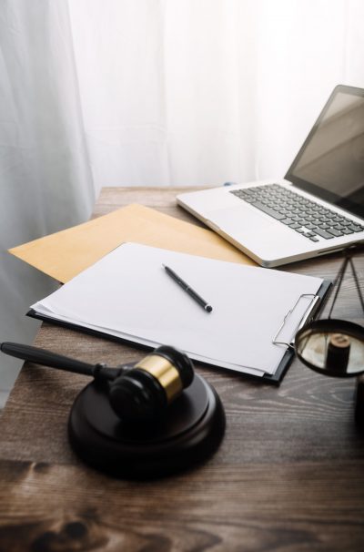 Business and lawyers discussing contract papers with brass scale