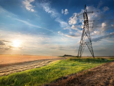 Electric pole in the autumn field at sunrise
